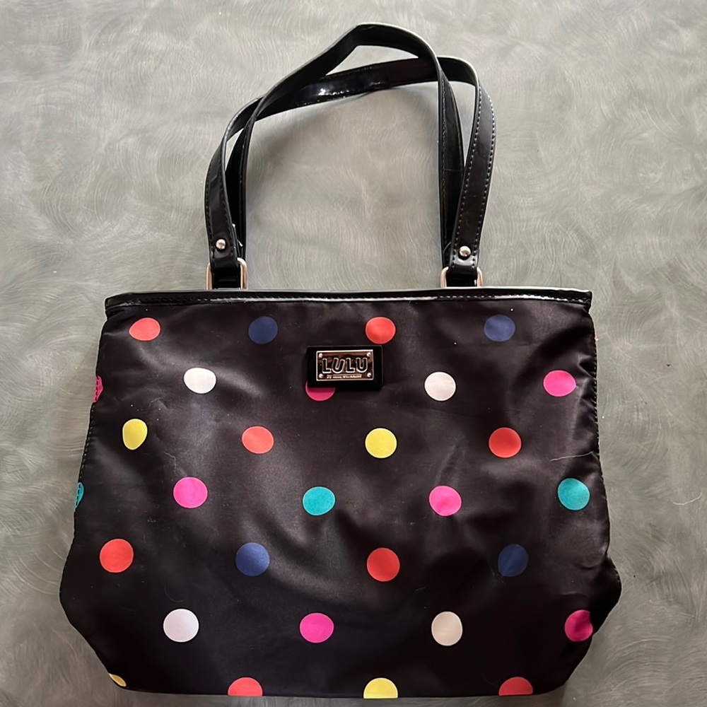 Black polyester bag with bright colored polka dots